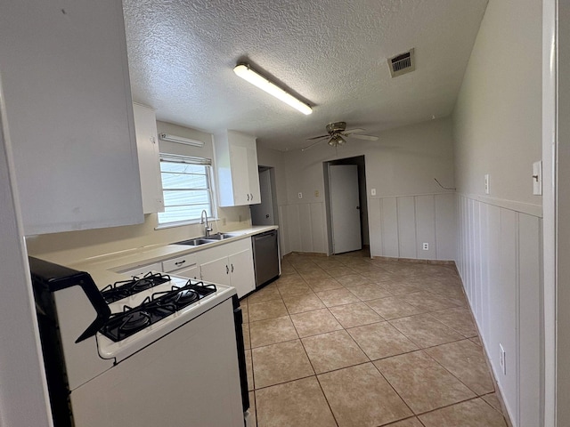 5115 Allen Dr, Beaumont, TX 77708 - kitchen with white range with gas cooktop, stainless steel dishwasher, white cabinetry, light countertops, and ceiling fan