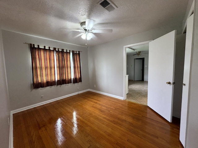5115 Allen Dr, Beaumont, TX 77708 - empty room featuring ceiling fan, light wood-type flooring, and a textured ceiling