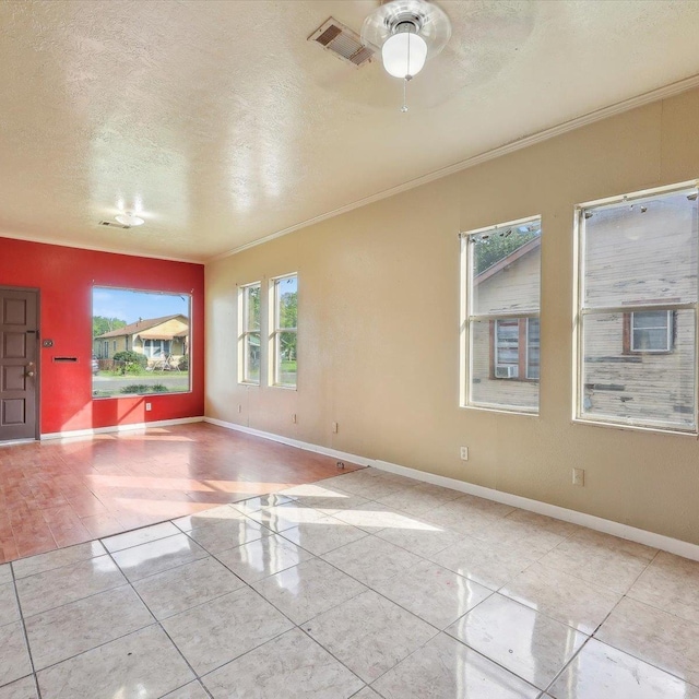 1710 17th St, Port Arthur, TX 77640 - tiled empty room with a ceiling fan, a textured ceiling, visible vents, and ornamental molding