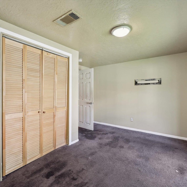 1710 17th St, Port Arthur, TX 77640 - unfurnished bedroom featuring visible vents, baseboards, dark carpet, and a closet