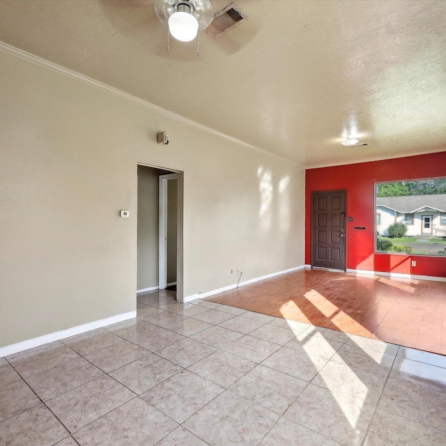 1710 17th St, Port Arthur, TX 77640 - spare room with crown molding, tile patterned flooring, a textured ceiling, and ceiling fan