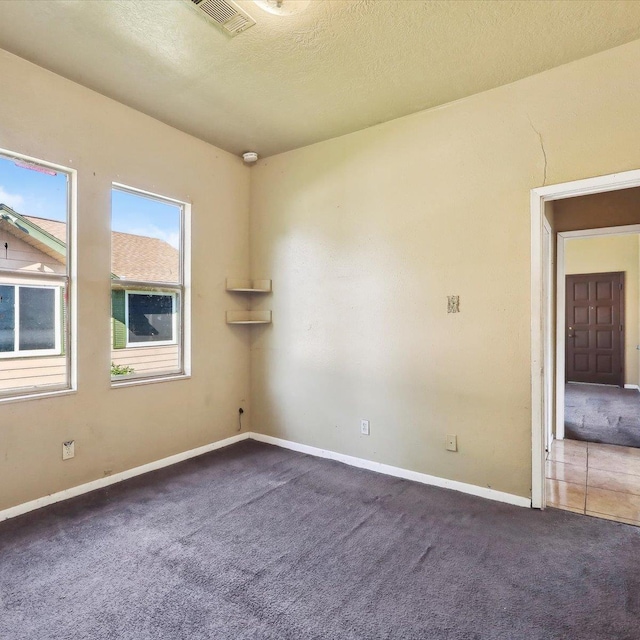 1710 17th St, Port Arthur, TX 77640 - empty room featuring carpet floors, a textured ceiling, baseboards, and visible vents