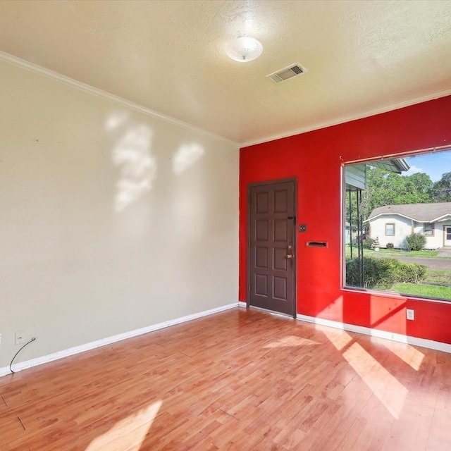 1710 17th St, Port Arthur, TX 77640 - unfurnished room featuring a textured ceiling, visible vents, wood finished floors, baseboards, and ornamental molding