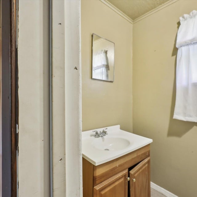 1710 17th St, Port Arthur, TX 77640 - bathroom featuring baseboards, ornamental molding, and vanity