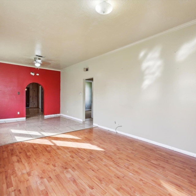 1710 17th St, Port Arthur, TX 77640 - spare room featuring crown molding, arched walkways, a ceiling fan, and wood finished floors