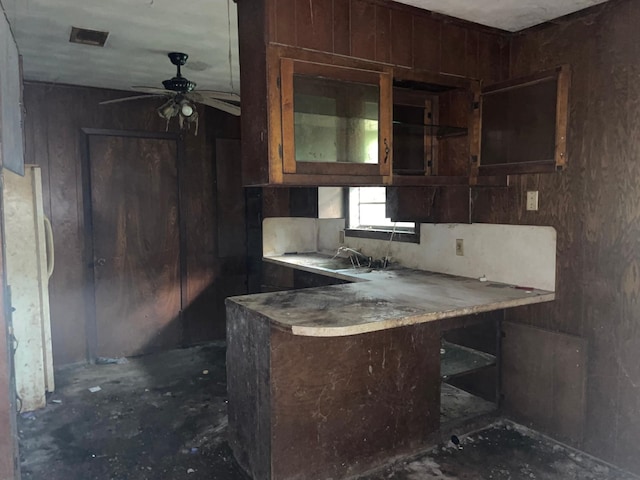 kitchen featuring fridge, ceiling fan, and sink