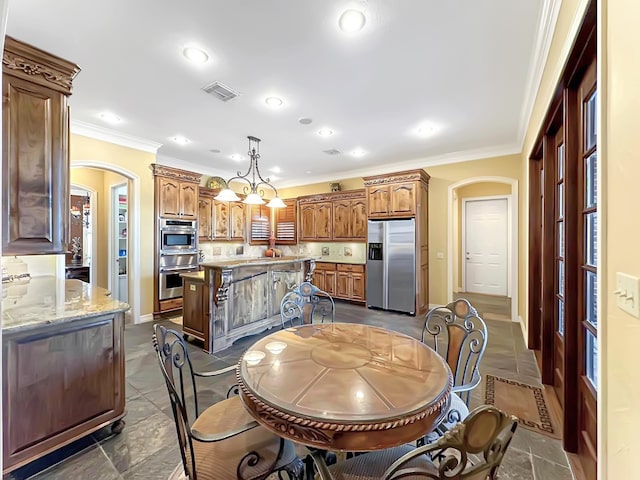 dining space with crown molding