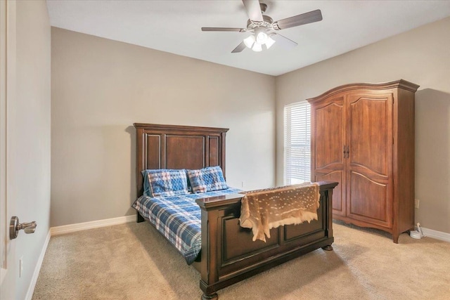 bedroom with ceiling fan and light carpet