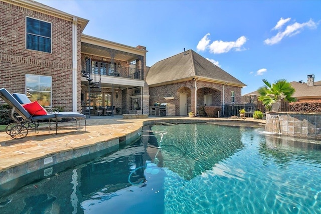 view of pool with pool water feature and a patio