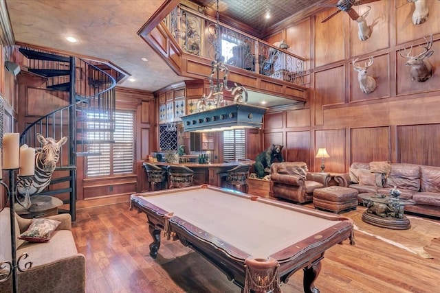 rec room featuring wood walls, ornamental molding, and billiards