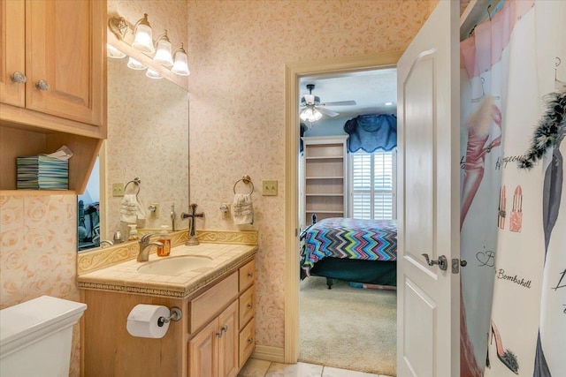 bathroom with ceiling fan, toilet, and vanity