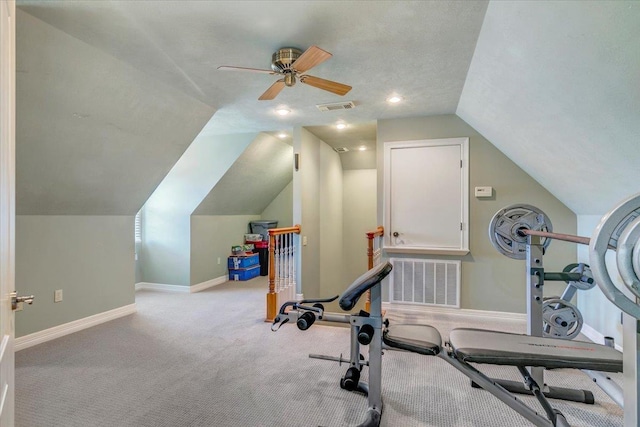 workout area with ceiling fan, a textured ceiling, light carpet, and vaulted ceiling