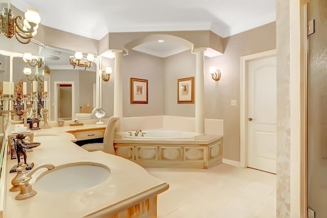 bathroom featuring decorative columns, a tub to relax in, ornamental molding, vanity, and a notable chandelier