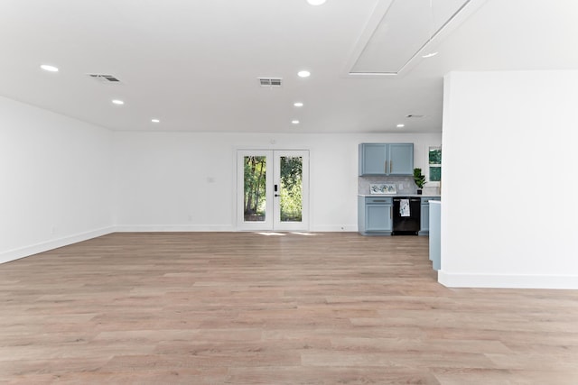 unfurnished living room with french doors and light hardwood / wood-style flooring