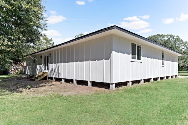 view of side of home with a yard