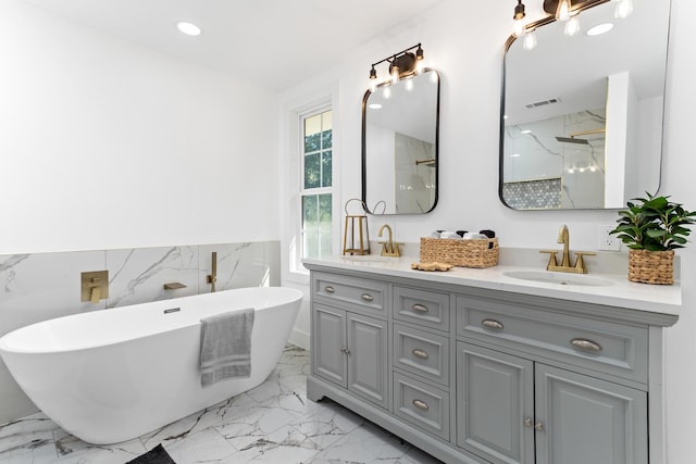 bathroom featuring vanity, independent shower and bath, and tile walls