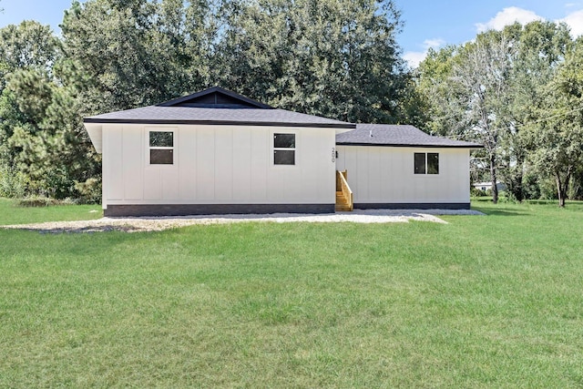 rear view of house with a yard