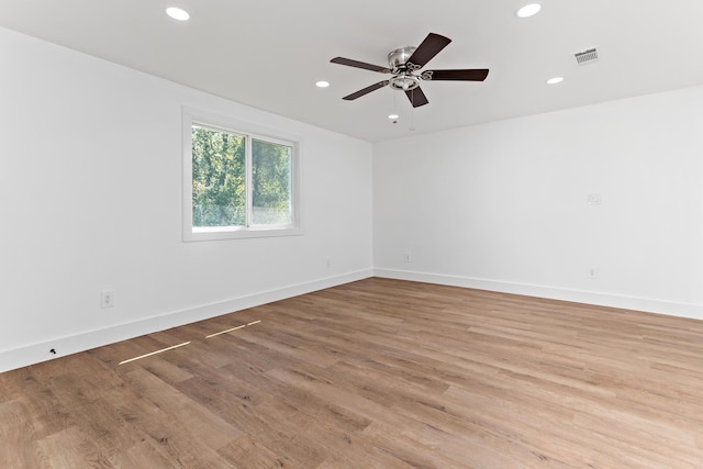 spare room with ceiling fan and light wood-type flooring