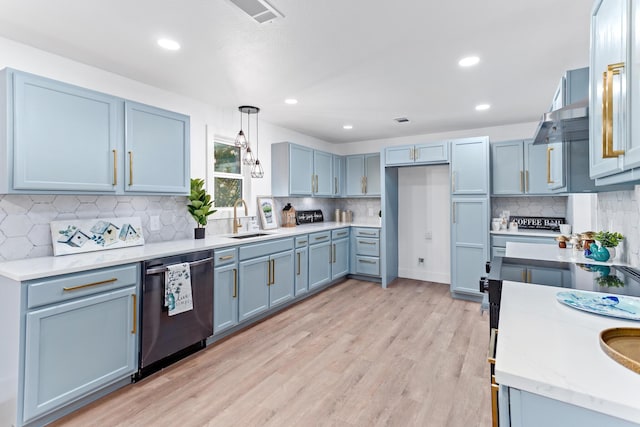 kitchen with dishwasher, sink, hanging light fixtures, decorative backsplash, and light hardwood / wood-style floors