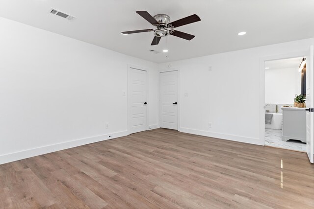 empty room with ceiling fan and light wood-type flooring