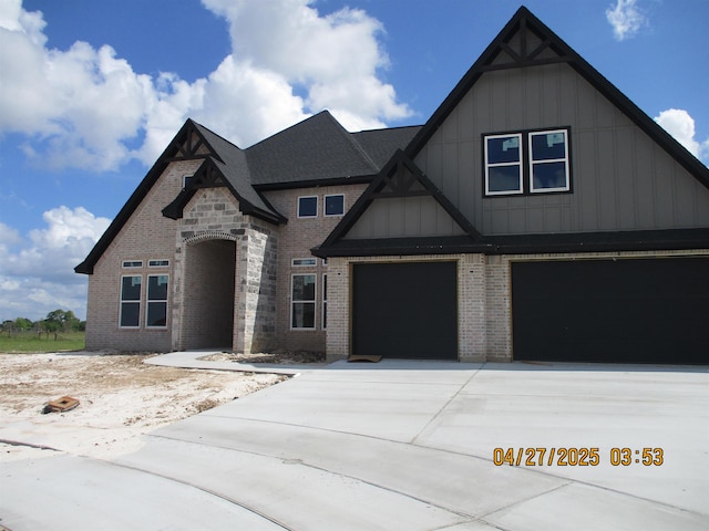 9145 Bellflower St, Beaumont, TX 77713 - view of front of property with board and batten siding, brick siding, driveway, and an attached garage