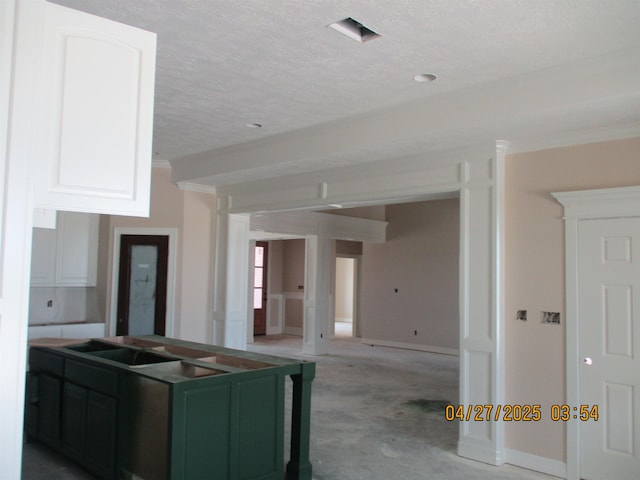 9145 Bellflower St, Beaumont, TX 77713 - kitchen featuring white cabinetry and a textured ceiling