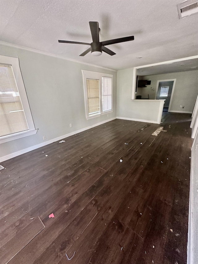 unfurnished living room featuring a textured ceiling, dark hardwood / wood-style flooring, ceiling fan, and ornamental molding