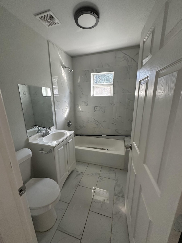 full bathroom with vanity, toilet, and tiled shower / bath combo