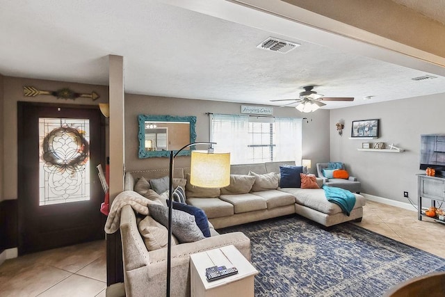 tiled living room featuring ceiling fan