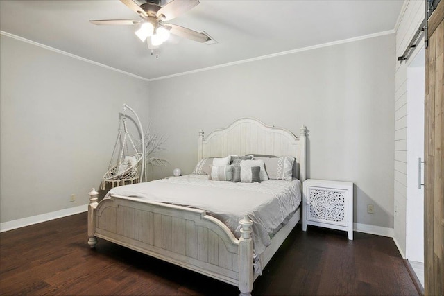 bedroom featuring ornamental molding, a barn door, ceiling fan, and dark wood-type flooring