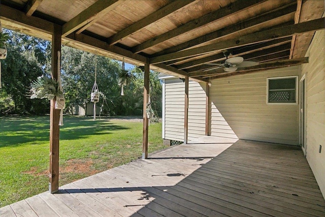 deck with a lawn and ceiling fan