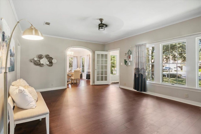 unfurnished room with ceiling fan, crown molding, and dark wood-type flooring