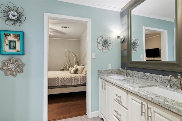 bathroom with hardwood / wood-style floors, vanity, and ornamental molding