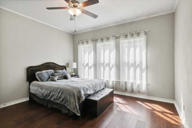 bedroom with crown molding, ceiling fan, and dark wood-type flooring