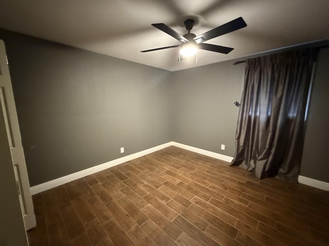 empty room featuring ceiling fan and dark hardwood / wood-style floors