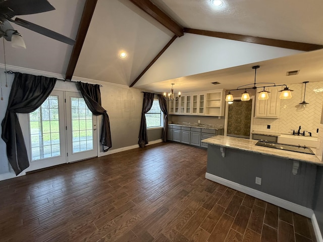 kitchen featuring ceiling fan with notable chandelier, lofted ceiling with beams, backsplash, and pendant lighting