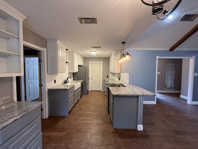 kitchen featuring a kitchen breakfast bar, dark hardwood / wood-style flooring, pendant lighting, white cabinetry, and backsplash