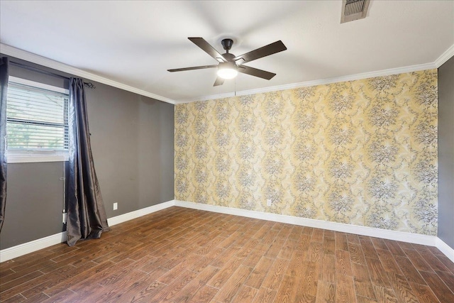 empty room featuring hardwood / wood-style flooring, ceiling fan, and ornamental molding