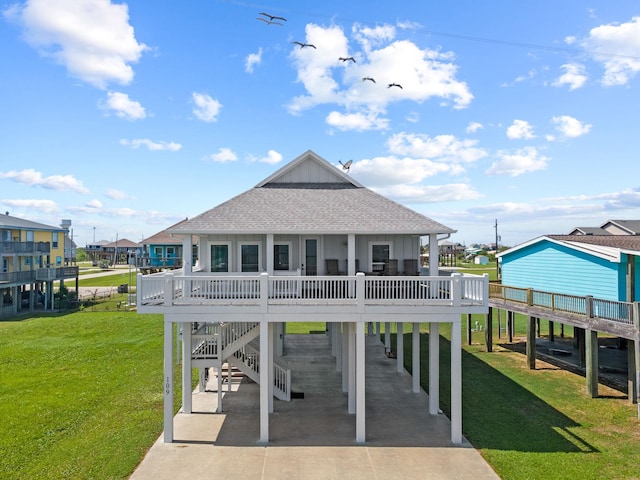 109 Ocean View Dr, Crystal Beach, TX 77650 - back of property featuring driveway, a carport, a residential view, roof with shingles, and a lawn