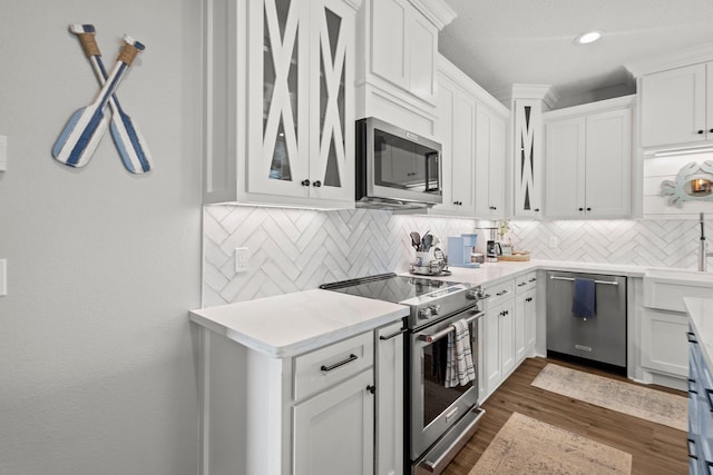 109 Ocean View Dr, Crystal Beach, TX 77650 - kitchen featuring glass insert cabinets, stainless steel appliances, white cabinets, backsplash, and dark wood-type flooring