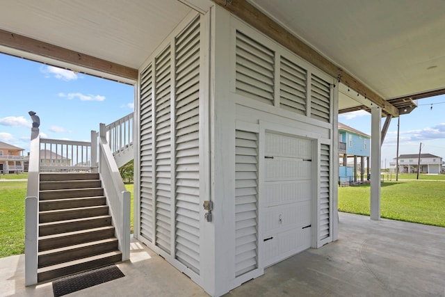 109 Ocean View Dr, Crystal Beach, TX 77650 - view of side of home with a residential view, a yard, a garage, and stairway