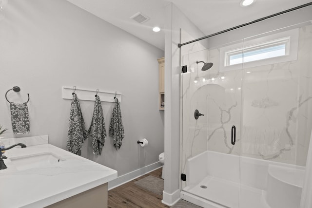 109 Ocean View Dr, Crystal Beach, TX 77650 - full bath with wood finished floors, toilet, baseboards, visible vents, and a marble finish shower