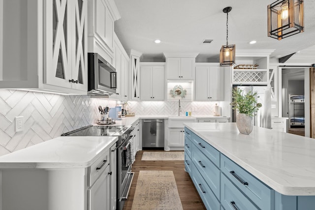 109 Ocean View Dr, Crystal Beach, TX 77650 - kitchen with a sink, stainless steel appliances, blue cabinetry, white cabinets, and dark wood finished floors