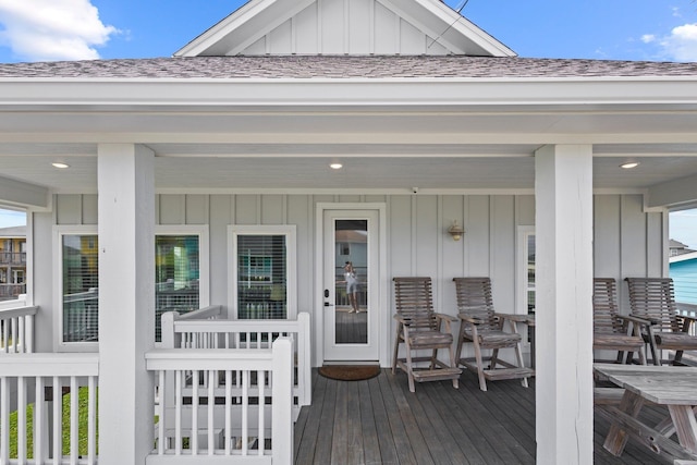 109 Ocean View Dr, Crystal Beach, TX 77650 - view of exterior entry featuring board and batten siding and a shingled roof