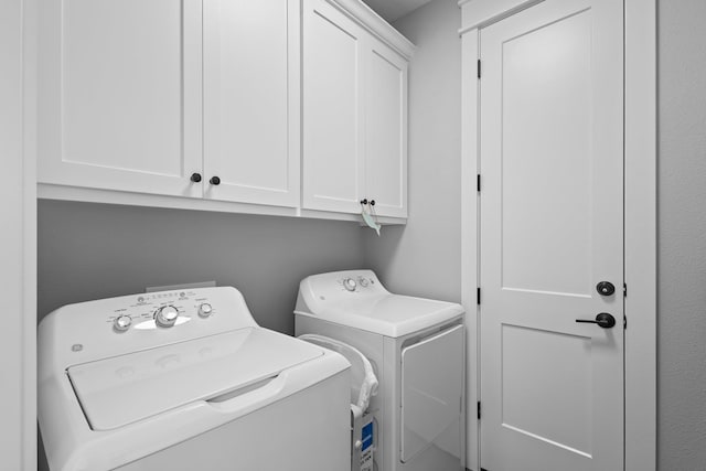109 Ocean View Dr, Crystal Beach, TX 77650 - clothes washing area with washer and dryer and cabinet space