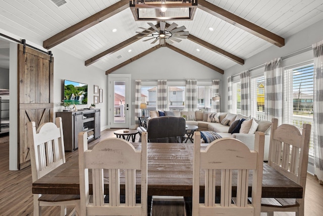 109 Ocean View Dr, Crystal Beach, TX 77650 - dining space featuring a barn door, light wood-style flooring, and beamed ceiling