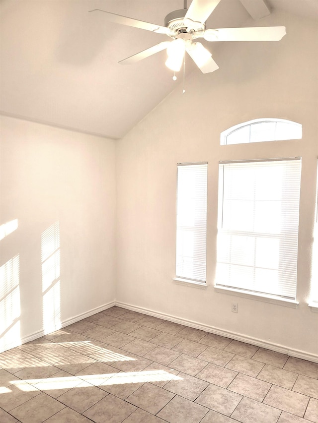 spare room featuring vaulted ceiling with beams and ceiling fan