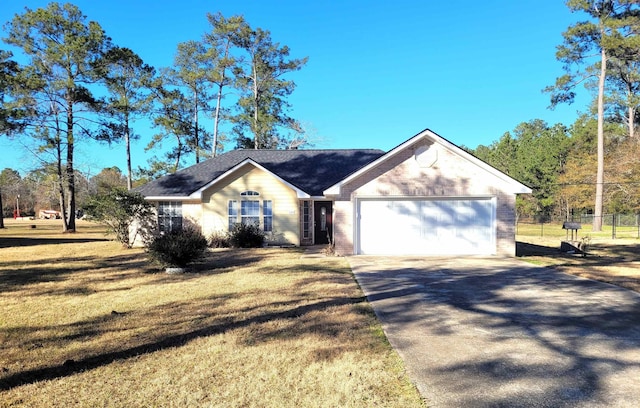 ranch-style home featuring a garage and a front yard