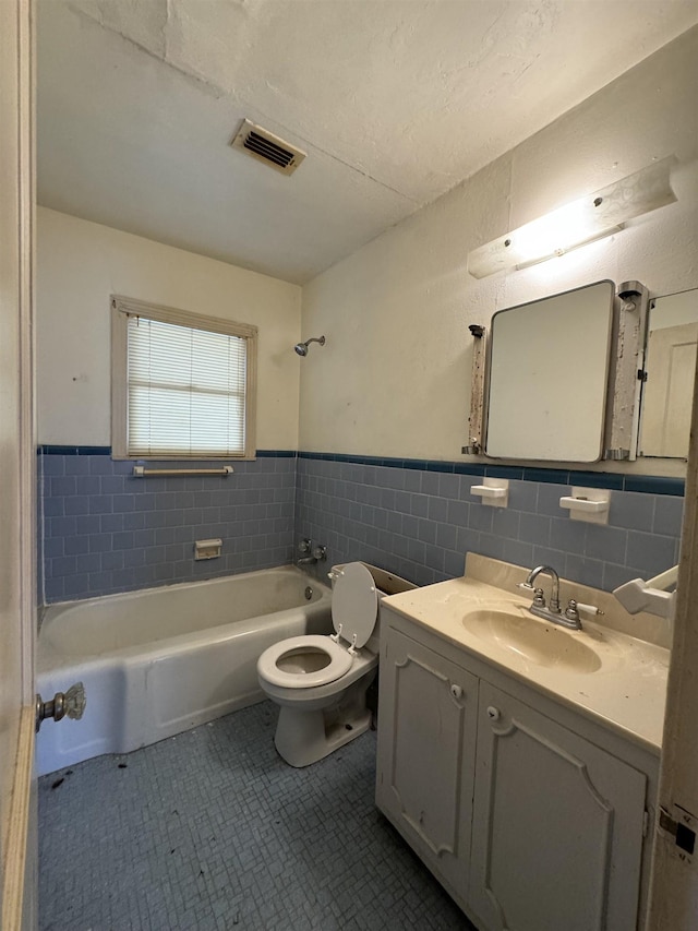 full bathroom featuring tile patterned flooring, vanity, toilet, and washtub / shower combination