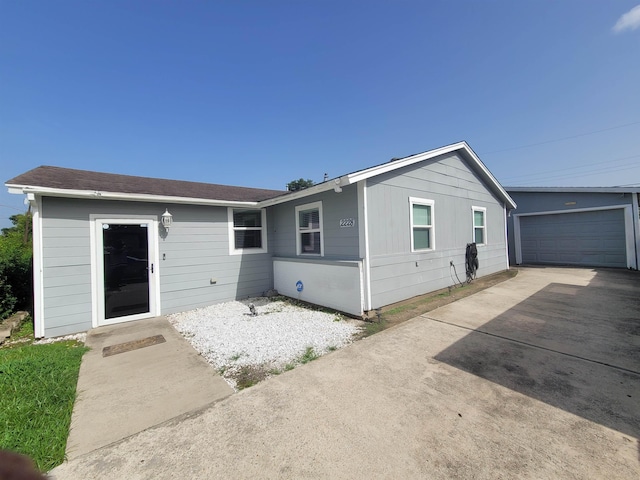 single story home with an outbuilding and a garage